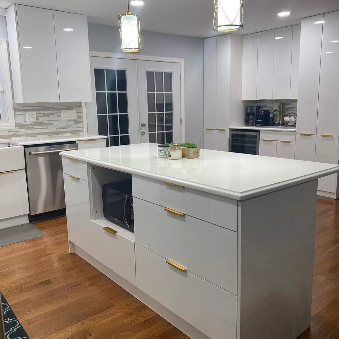 Calacatta quartz kitchen island with white cabinetry and gold hardware installed by LG Granite